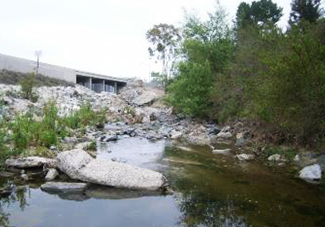 Image of a waterway running under a road