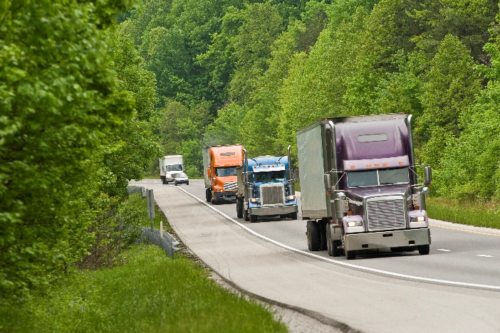 Highway Full Of Trucks In The Mountains