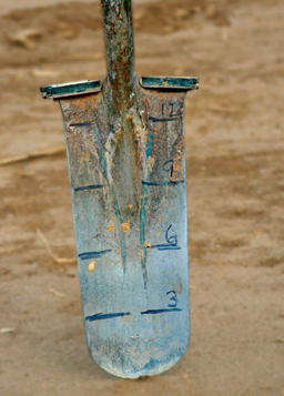 Photo of a shovel with inches marked on it