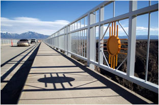 Photograph: Zia symbol cast on bridge over the Rio Grande Gorge, Taos New Mexico.