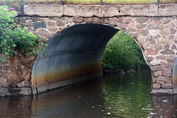 Steel pipe culverts, like this one with a stone headwall, provide for continuous flow under the width of the roadway (HAER CT-193).  (Image courtesy of Rob Tucher.)