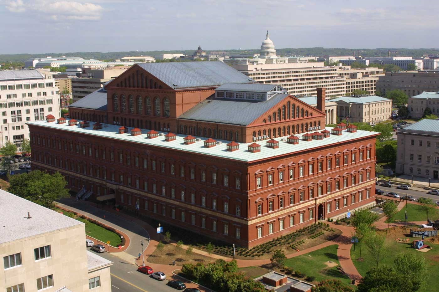 A photograph of a multi-level brick building, known as the National Building Museum in Washington, D.C.