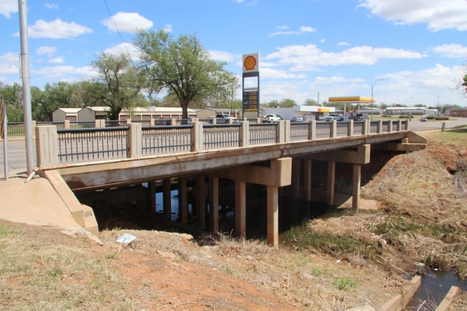 A photograph of a bridge with adjacent archeological sites next to it.