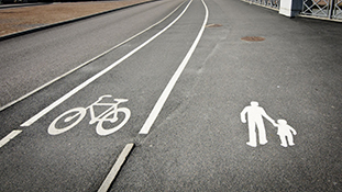 A street with a designated bike lane and walking lane