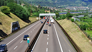 A highway with cars and trucks on it.