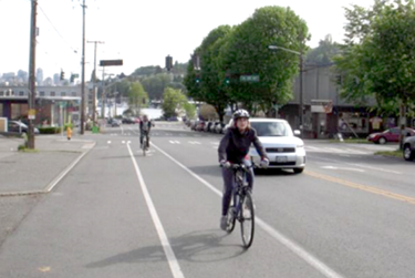 photograph of a section of Stone Way Road showing the new bicycle lane and the new center two-way left-turn lane