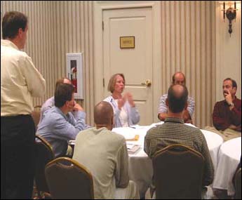 Participants of the workshop gathered around tables to discuss workshop materials.