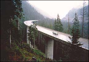 Major highway through forest, illustrating how workshops have fostered a climate of understanding and cooperation between Federal state and tribal teams who work to deliver environmentally sound transportation programs.