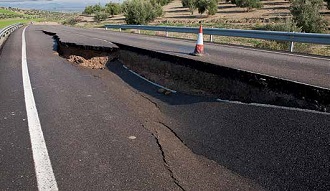 photo of a sinkhole in a road