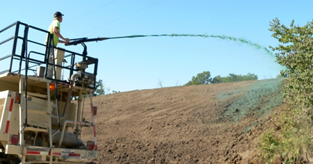 photo of slope being hydroseeded from shoulder