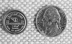 Photo of an iButton next to a nickel