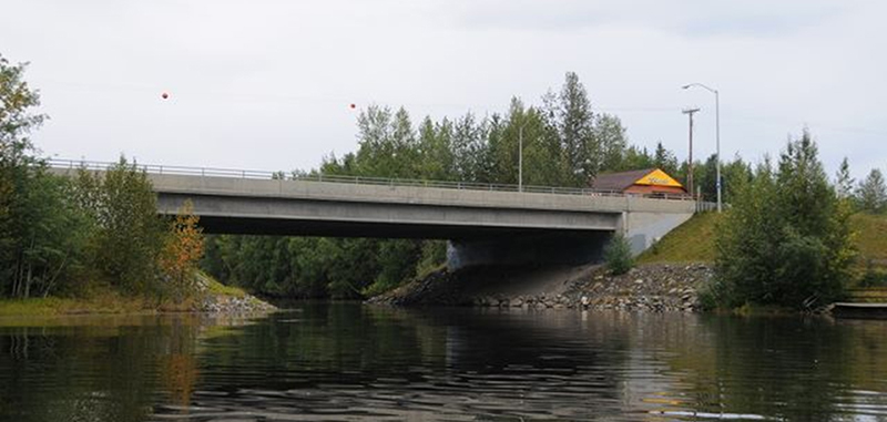 Photograph of a short concrete bridge over a creek