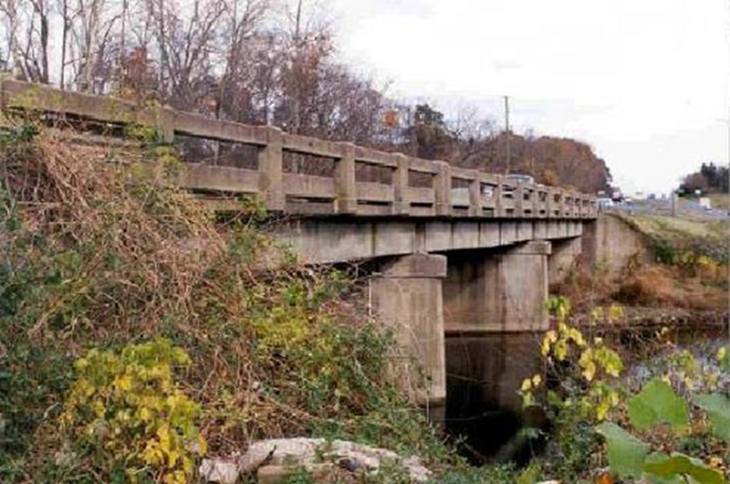 Photograph of a short concrete bridge over a creek