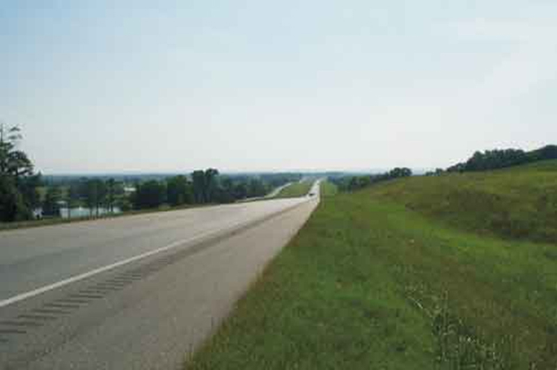 Photograph of a long stretch of highway, receding into the horizon