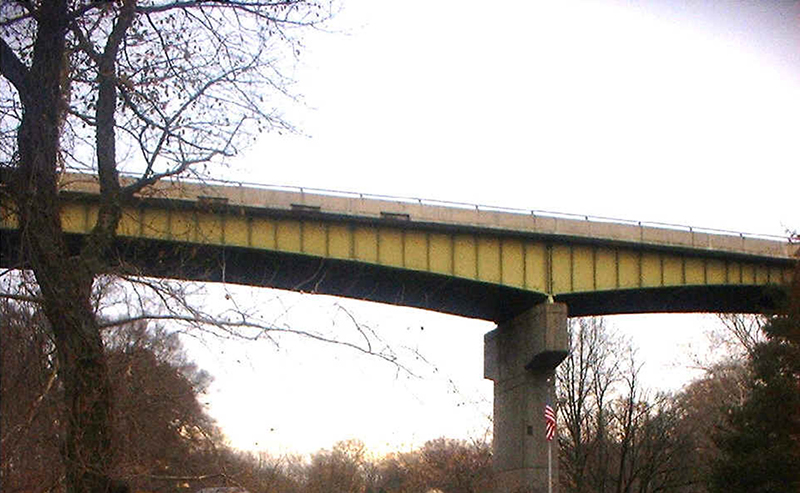 Photograph looking up at the side of a bridge