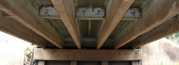 Reinforced-concrete tee beams feature T-shaped members that support an integral deck and road surface.  (Image courtesy of Mead & Hunt, Inc.)