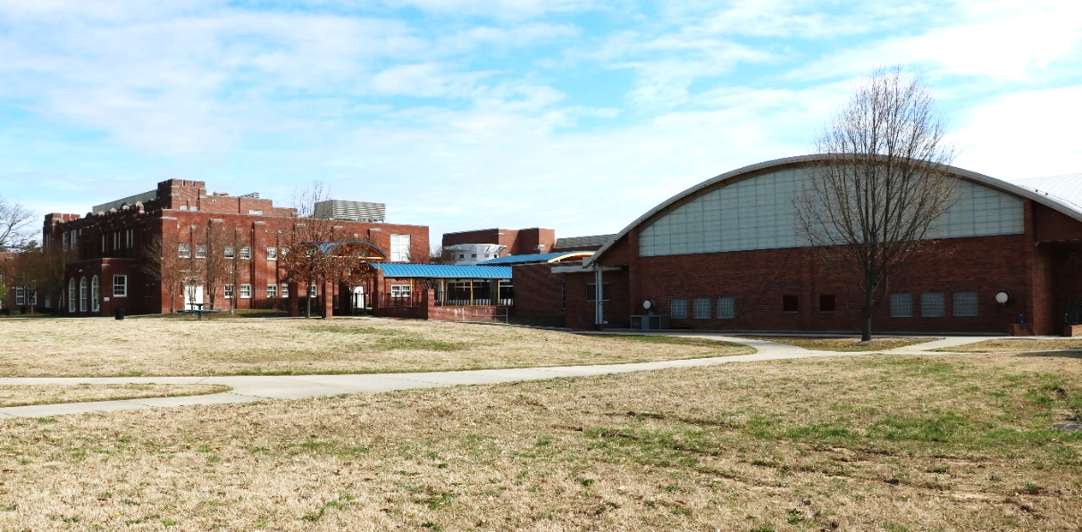 A photograph of two brick buildings at the Dudley High School campus