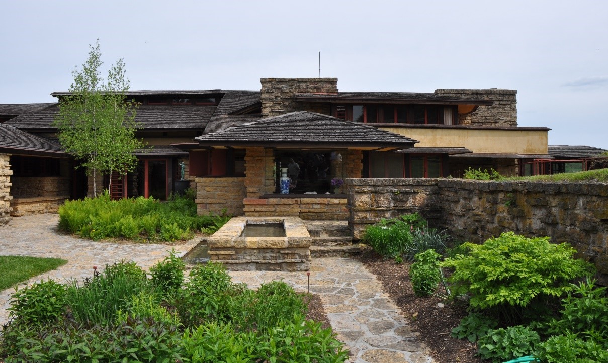 A photograph of the front of a house with landscaping and walkway.