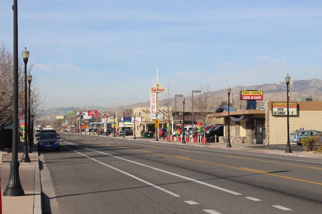 A photograph of a streetscape with businesses lining the street.