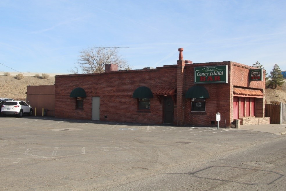 A photograph of a brick building with the sign “Coney Island Bar”.