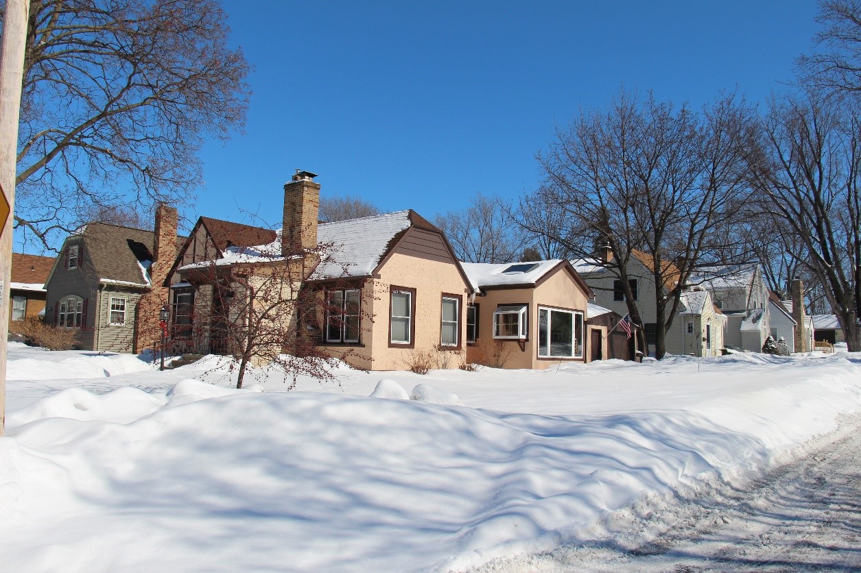 A photograph of a historic home in the winter time.