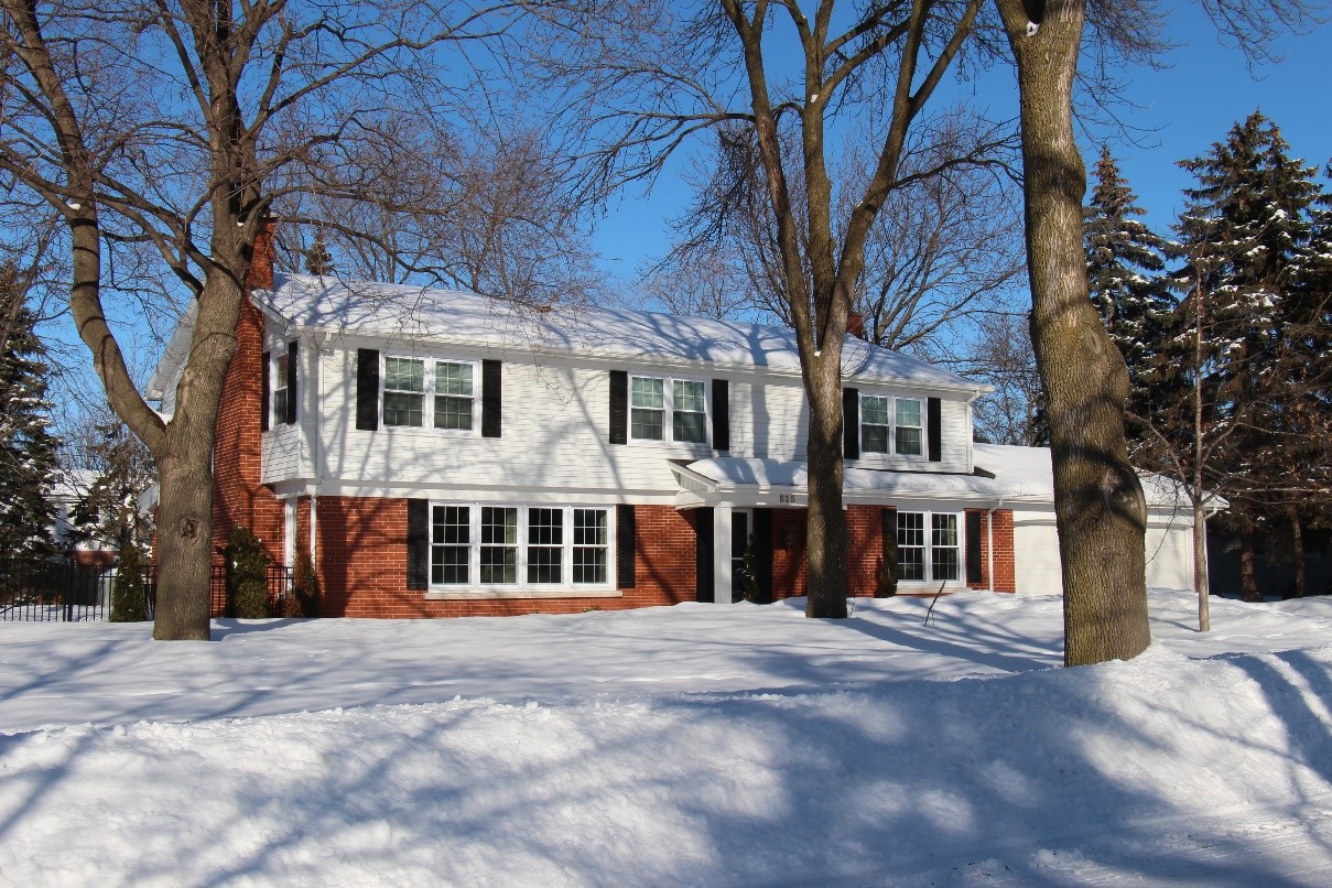 A photograph of a historic home in the winter time.