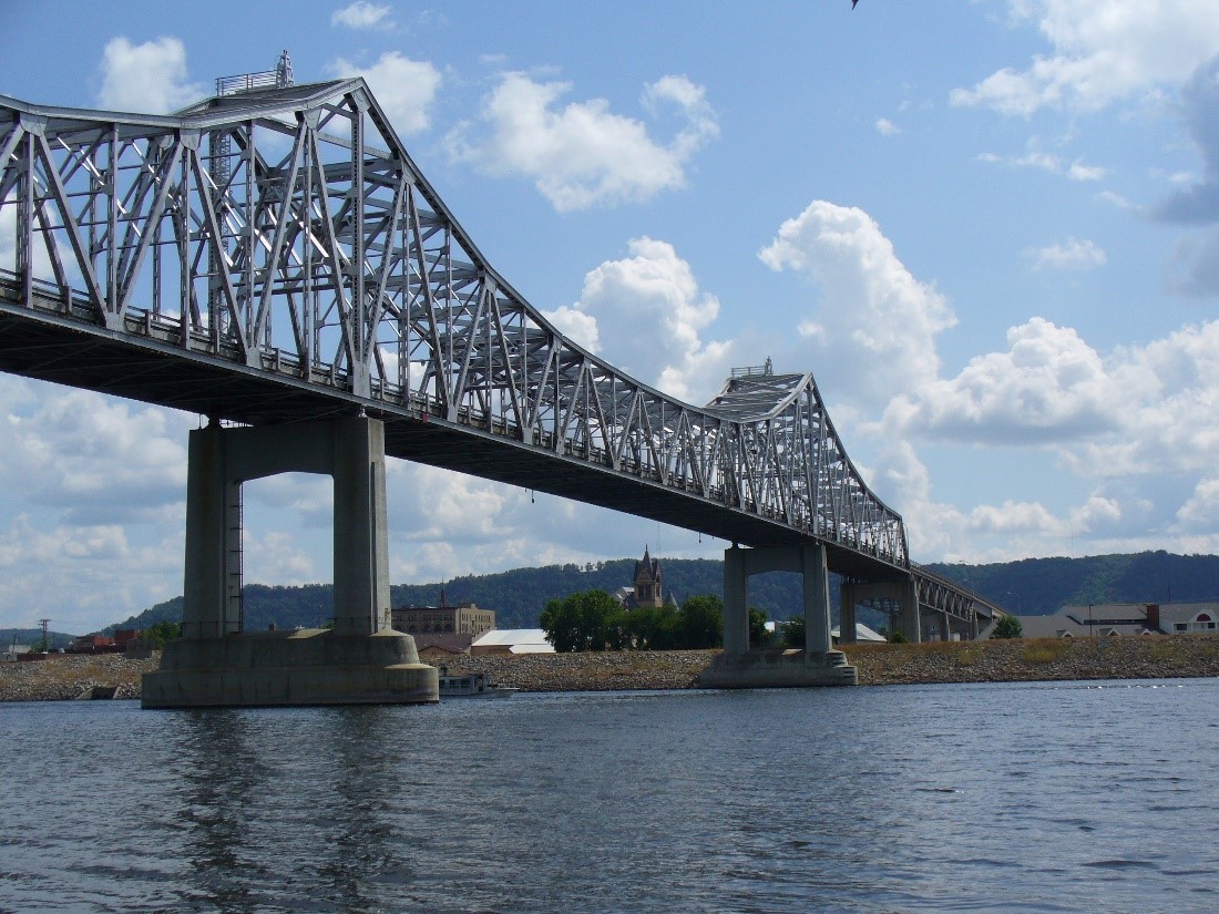 A photograph of a large truss bridge spanning a waterway.