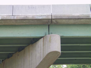 photo of an open concrete joint on the side of a bridge