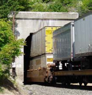 Photograph of a train passing through a notched tunnel