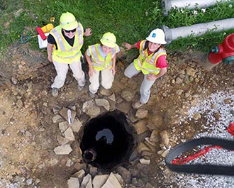 photo of three PennDOT PHAST crew in hard hats at a field site