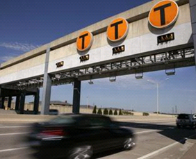 Photograph of cars passing underneath an electronic toll collection system