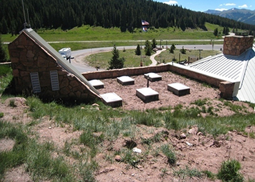 Photograph of the Vail Pass Rest Area and Visitor Center, looking down from atop the hill that the Visitor Center is built into