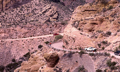 Photograph of a road crew working near a section of the Apache Trail's historical stone wall