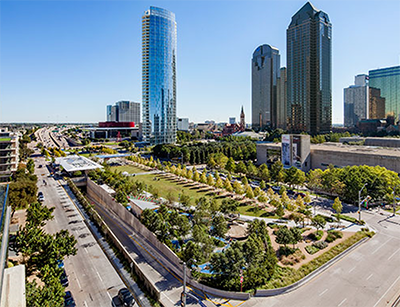photo of Klyde Warren Park with tall skyscrapers in the background