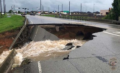 photo of a large sinkhole containing rushing water