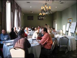 Participants gathered around tables to discuss workshop materials. Activities and discussions were highly interactive including breakout discussions, role-plays and fishbowl exchanges.