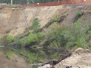 Photograph of a storm-damaged slope of the Saranac River