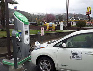 Photograph of an Electric Vehicle (EV) being charged at an EV charging station at a rest area along I-5 in Oregon